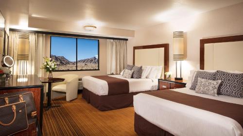 a hotel room with two beds and a window at Rainbow Hotel Casino by Peppermill Resorts in West Wendover