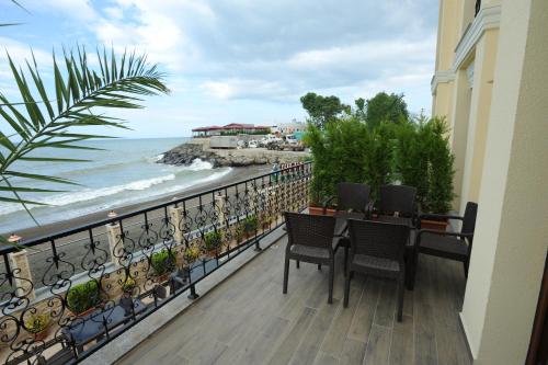 a balcony with a table and chairs and the ocean at Vurna Butik Hotel in Trabzon