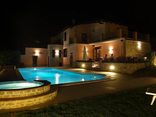 una piscina frente a una casa por la noche en Agriturismo La Costa, en Torre Bormida