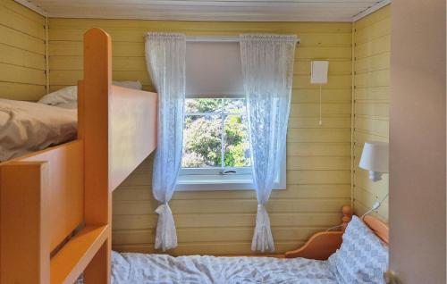 a room with a bunk bed and a window at 4 Bedroom Gorgeous Home In Steinsland in Steinsland
