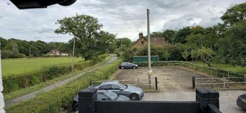 a car parked in a parking lot next to a road at The George and Dragon Pub in Shipley