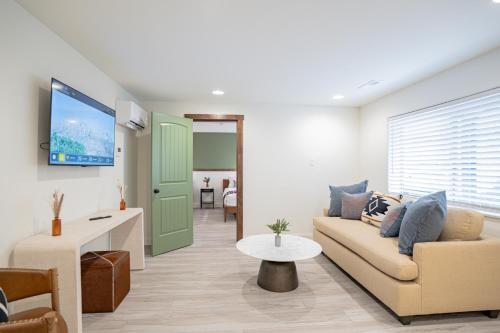 a living room with a couch and a tv at Petty Ranch Inn in Springdale