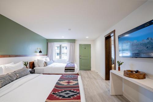 a hotel room with a bed and a tv at Petty Ranch Inn in Springdale