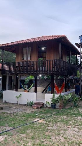 a house with a balcony and a playground at Chalés Soares e Sousa in Santarém