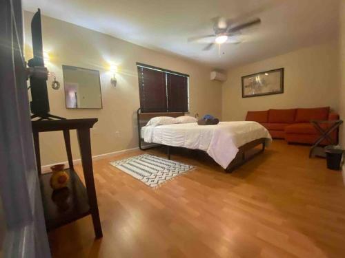 a bedroom with a bed and a couch at Casa Bugambilia near Miami Airport in Miami