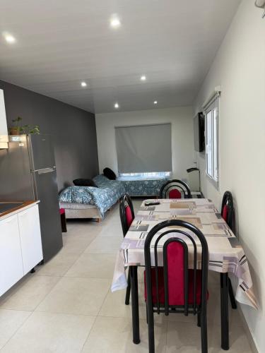 a room with a table and chairs and a kitchen at Departamento temporal in Comodoro Rivadavia