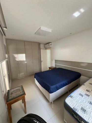 a bedroom with a bed and a table in it at Búzios Mansion Canal Area in Búzios