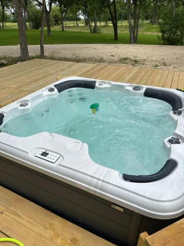 a hot tub on a wooden deck with at Rustic Luxe Yurt- Unit #1 in Woodway
