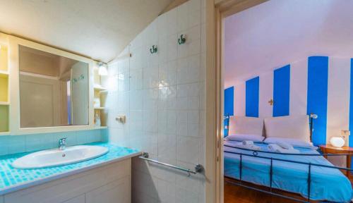 a bathroom with a sink and a mirror at Le Terrazze di Porto Rotondo - Vista Mare in Porto Rotondo