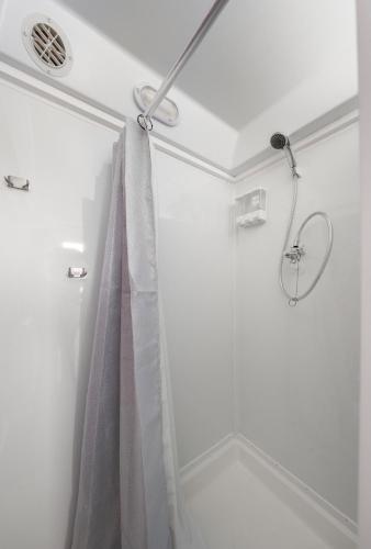 a shower in a bathroom with a shower curtain at Jungle Haven Yurt- Unit #2 in Woodway