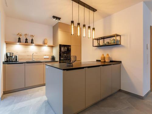a kitchen with a large island in a room at Mountain Chalet Chapeau in Sankt Lorenzen ob Murau