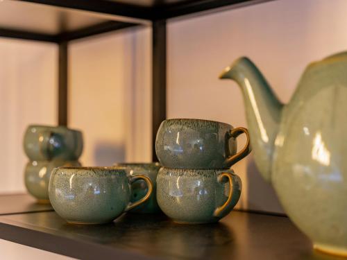 a group of green cups sitting on a table at Mountain Chalet Chapeau in Sankt Lorenzen ob Murau