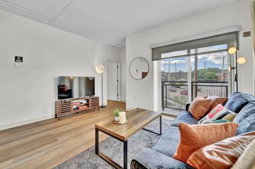 a living room with a couch and a table at Stay in Cleveland mins to Cleveland Clinic, Hospitals, Museum, Universities & Downtown in Cleveland