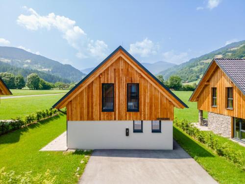 a wooden house with a white garage at Mountain Chalet Krek Wak Wou in Sankt Lorenzen ob Murau