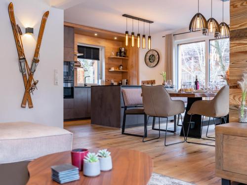a kitchen and living room with a table and chairs at Mountain Chalet Arnica in Sankt Lorenzen ob Murau