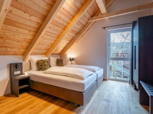 a bedroom with a large bed and a large window at Mountain Chalet Arnica in Sankt Lorenzen ob Murau