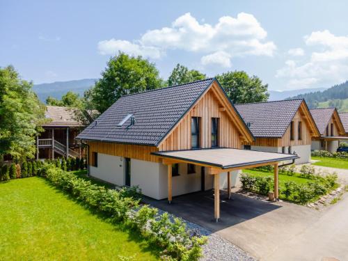 a home with a tennis court in the yard at Mountain Chalet Arnica in Sankt Lorenzen ob Murau