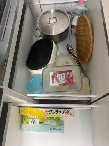 a refrigerator filled with lots of food and utensils at Shiro の秘密基地 in Ōmagari
