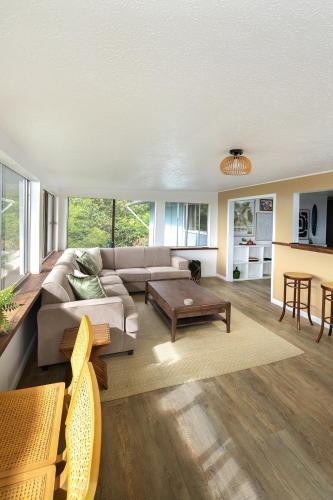 a living room with a couch and a table at Lihau Boho House in Kailua-Kona