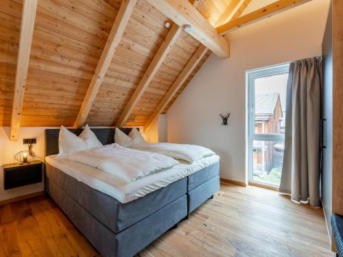 a large bed in a room with a large window at Bergzicht 2A in Sankt Lorenzen ob Murau