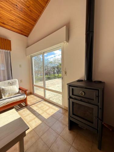 a living room with a stove and an open door at Casa Lago in Santa Ana