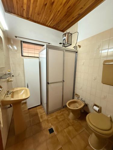 a bathroom with a shower and a toilet and a sink at Casa Lago in Santa Ana