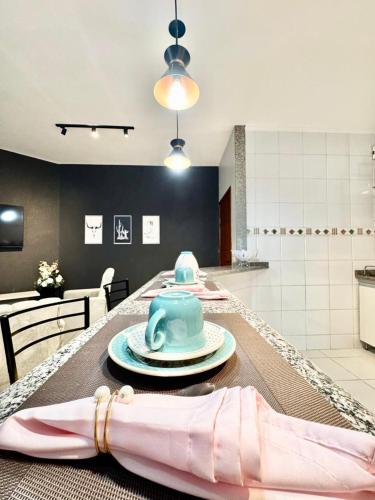 a table with a blue tea pot on top of it at APARTAMENTO CONFORT NO CENTRO Ar cond 2 QUARTOS in Formosa