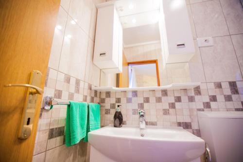 a bathroom with a sink and a mirror at Golden Gate Dream Rooms in Split