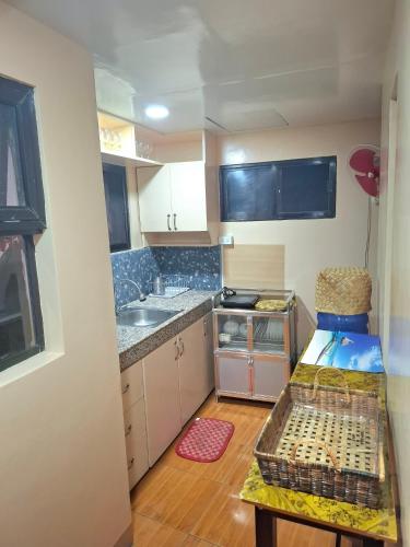 a small kitchen with a sink and a counter at Luxury Penthouse With View&Starlink in Dapa