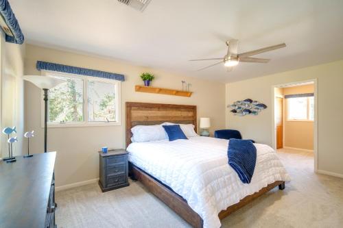a bedroom with a bed and a ceiling fan at Lovely Riverfront Grants Pass Home Pool and Hot Tub in Grants Pass