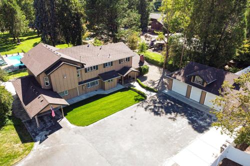 an aerial view of a house with a yard at Lovely Riverfront Grants Pass Home Pool and Hot Tub in Grants Pass