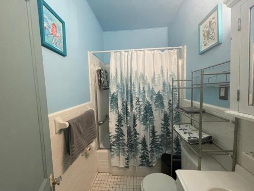 a bathroom with a shower curtain with trees on it at Dog Friendly 1 bd 1 ba near Airport and Marta in Atlanta