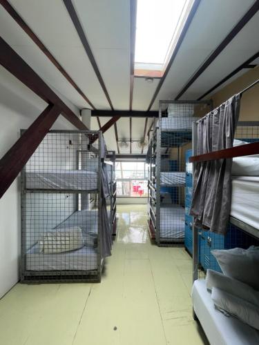 a room with several cages in a room at The Yak Lake House - Hostal Bacalar in Bacalar