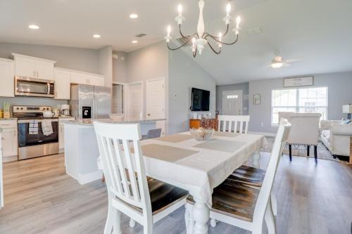 a kitchen and dining room with a white table and chairs at COZY home with fenced patio in Ocala