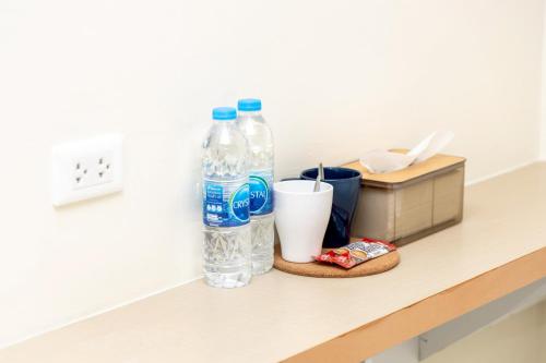 a counter with two bottles of water and a cup at Sea Inn Pattaya in Pattaya Central