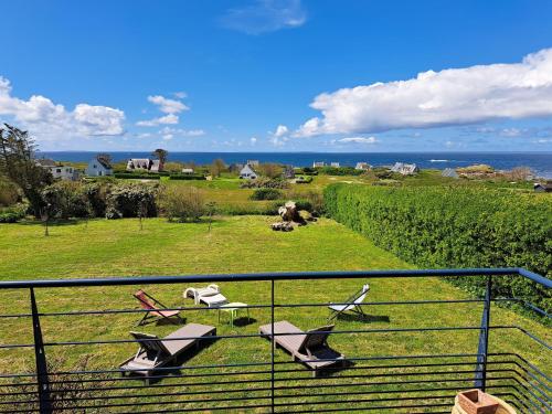 a balcony with chairs and a view of the ocean at Holiday Home in Brittany with Sea View in Lampaul-Plouarzel
