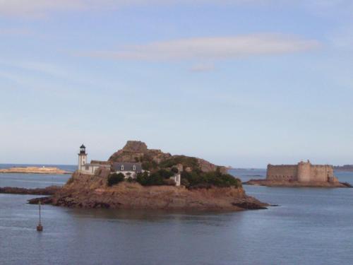 a small island in the water with a lighthouse at Flat in Primel with Sea View & Beaches Nearby in Plougasnou