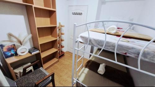 a small room with a bunk bed and shelves at CK Condotel at Sanremo Oasis in Cebu City