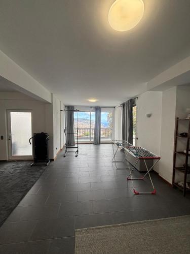 an empty living room with a large window and a room with a floor at Casa Barcelos in Funchal