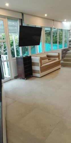 a large living room with a flat screen tv at Finca Hotel los Nogales in Quimbaya
