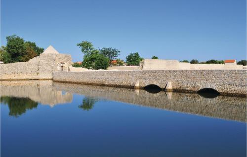 a stone bridge over a body of water at Cozy Apartment In Nin With Wifi in Nin
