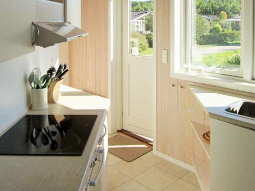 a kitchen with a sink and a stove top oven at 5 person holiday home in Rude-By Traum in Rude