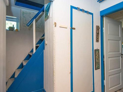 a staircase with blue and white walls and a blue door at 6 person holiday home in Brædstrup-By Traum in Brædstrup