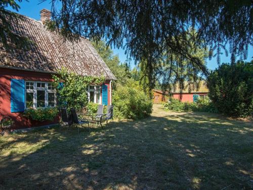 a red house with a bench in front of it at 6 person holiday home in Brædstrup-By Traum in Brædstrup