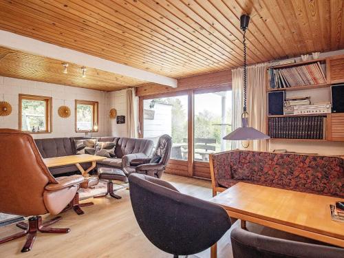 a living room with couches and chairs and a table at 10 person holiday home in Fur in Fur