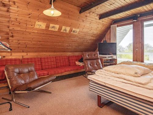 a bedroom with a couch and a bed and a tv at 10 person holiday home in Fur in Fur