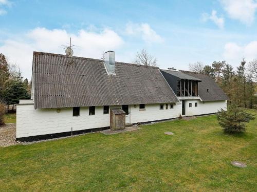 a white barn with a roof on a field at 10 person holiday home in Fur in Fur