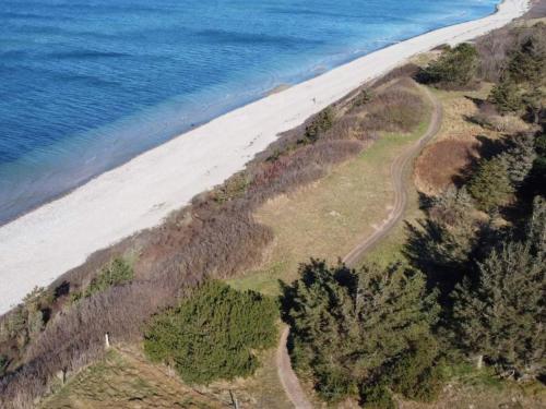 an aerial view of a beach next to the ocean at Luxury Villa with Pool - By Traum Ferienwohnungen in Vejby