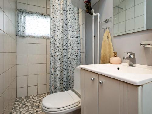 a bathroom with a toilet and a sink and a shower at 6 person holiday home in Væggerløse in Marielyst