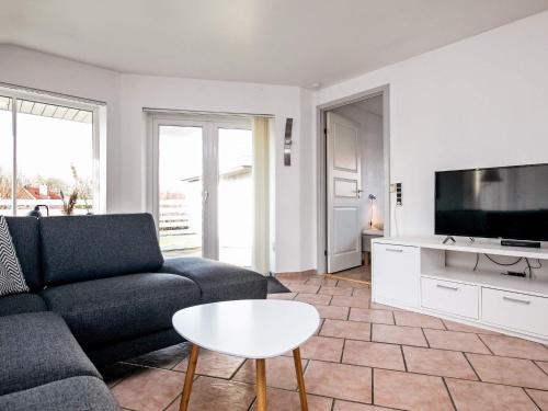 a living room with a couch and a tv at 6 person holiday home in Humble-By Traum in Humble